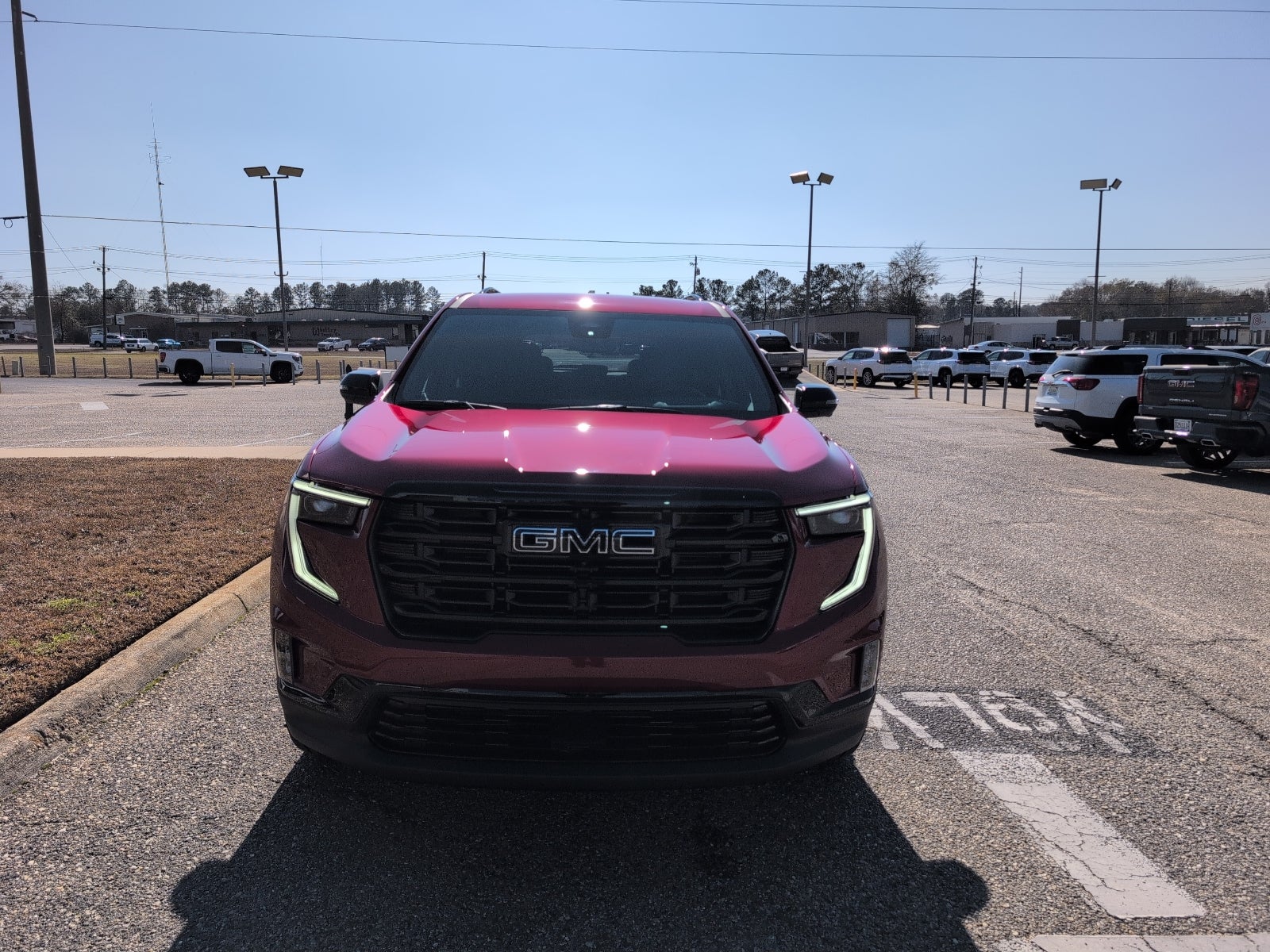 2026 GMC Acadia Elevation in Volcanic Red Tintcoat — front three-quarter view
