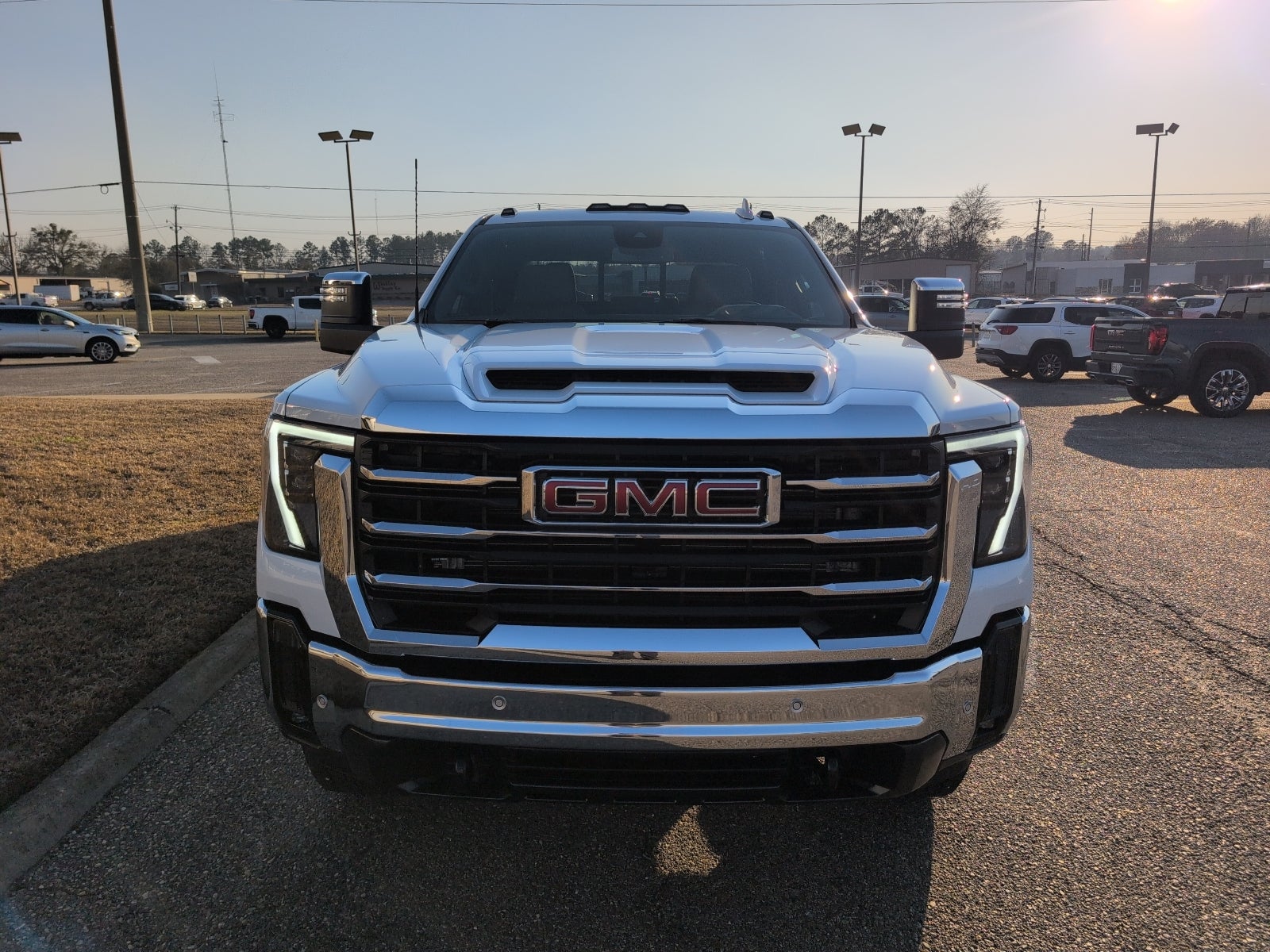 2026 GMC Sierra 2500 HD SLT in Glacier White Tricoat — front three-quarter view