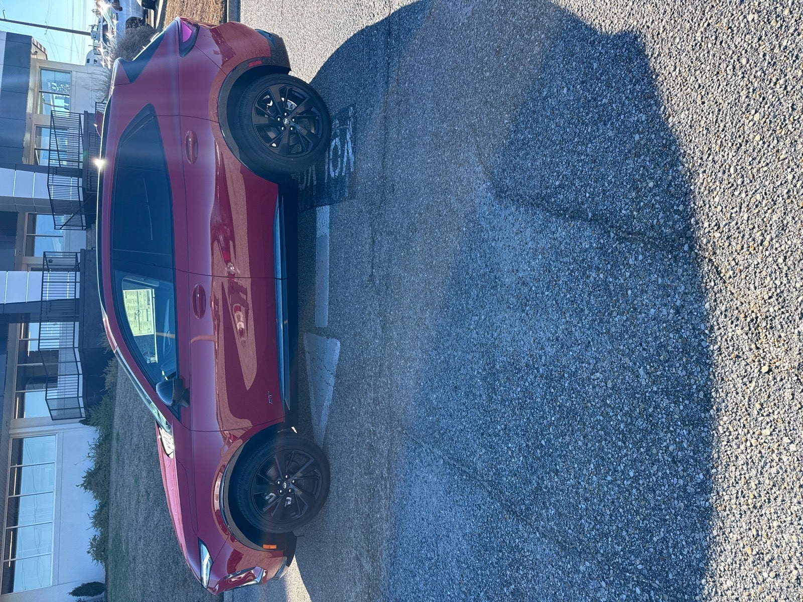 2025 Buick Envision Sport Touring in Brilliant Red — front three-quarter view